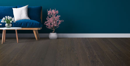 Featured Image: dark hardwood floors and dark green walls with white trim