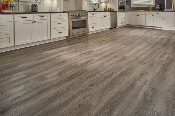 vinyl plank flooring in a kitchen with white cabinetry